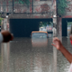 Local residents look at a submerged bus in a waterlogged road underpass after monsoon rainfalls in New Delhi